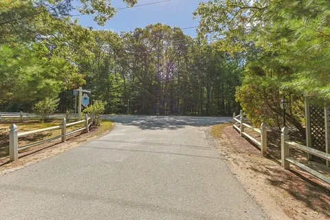 a picture of a bench in front of a white house