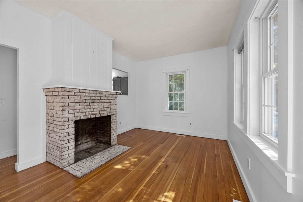 3040 Falmouth Road, Unit H Barnstable, MA 02655 - Photo 7 of 26 a living room with a fireplace and wooden floor