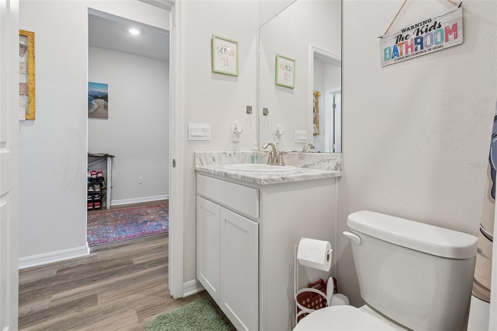 11965 Muskegon Court Parrish, FL 34219 - Photo 26 of 74 a bathroom with a toilet sink and mirror