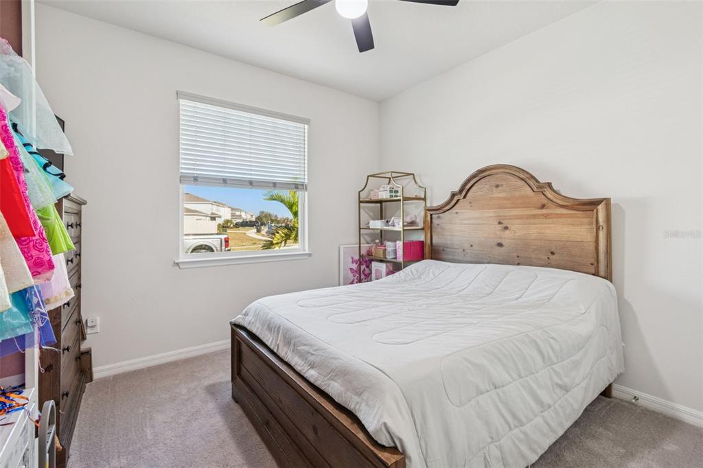 11965 Muskegon Court Parrish, FL 34219 - Photo 41 of 74 a bedroom with a bed and a chandelier