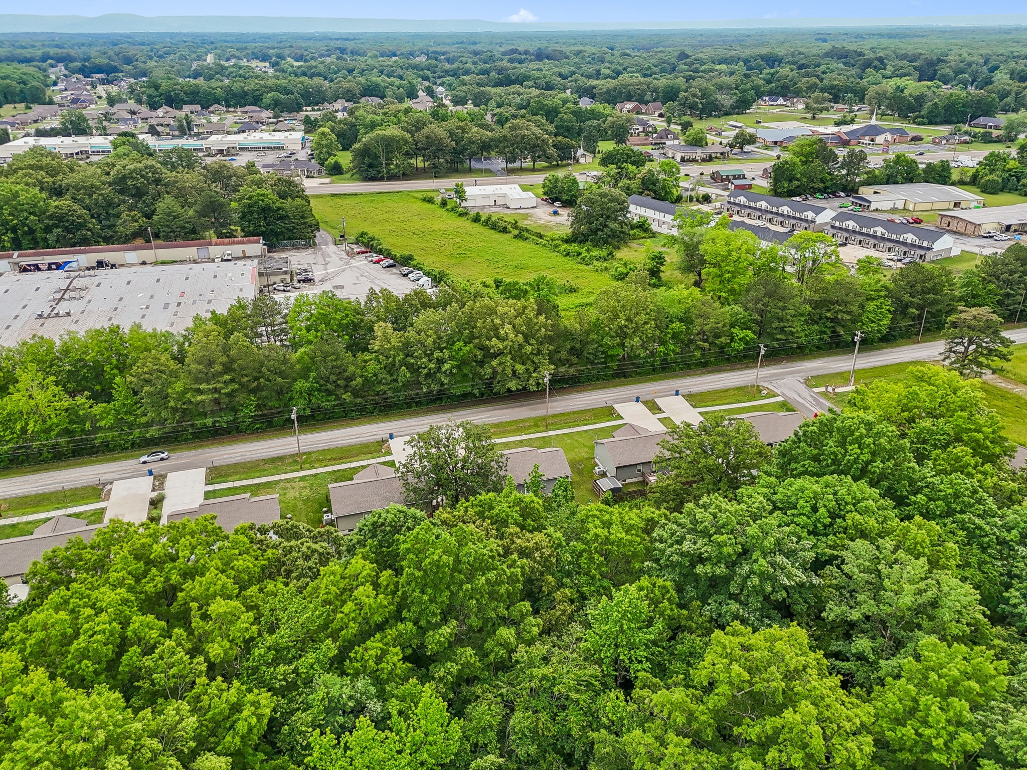 1546 South Spring Street Manchester, TN 37355 - Photo 50 of 53 an aerial view of green landscape with trees lake and ocean view