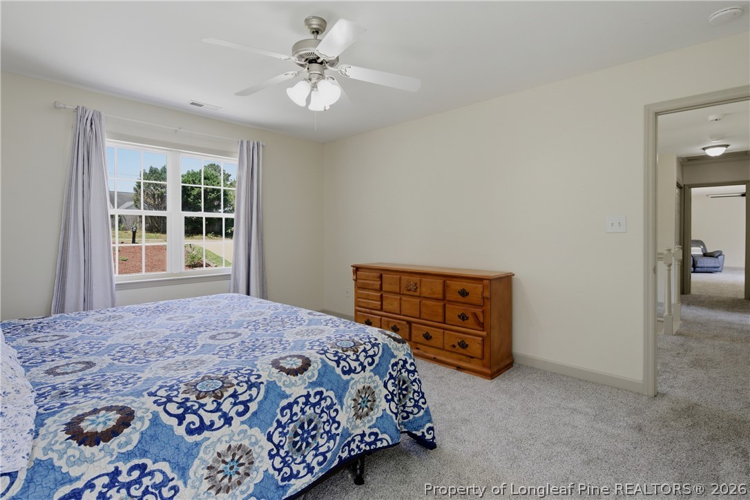 1075 Buffalo Lake Road Sanford, NC 27332 - Photo 25 of 49 a bedroom with a bed dresser and a window