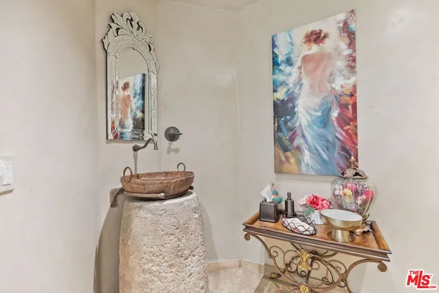 a bathroom with a mirror and a sink