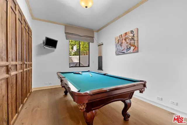 a room with pool table and windows