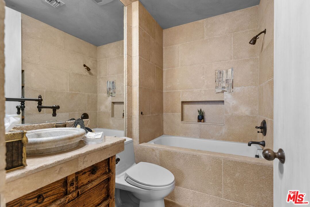 605 North Hillcrest Road Beverly Hills, CA 90210 - Photo 15 of 36 a bathroom with a sink a toilet and shower