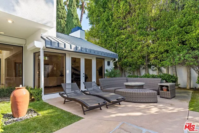 a view of a patio with table and chairs