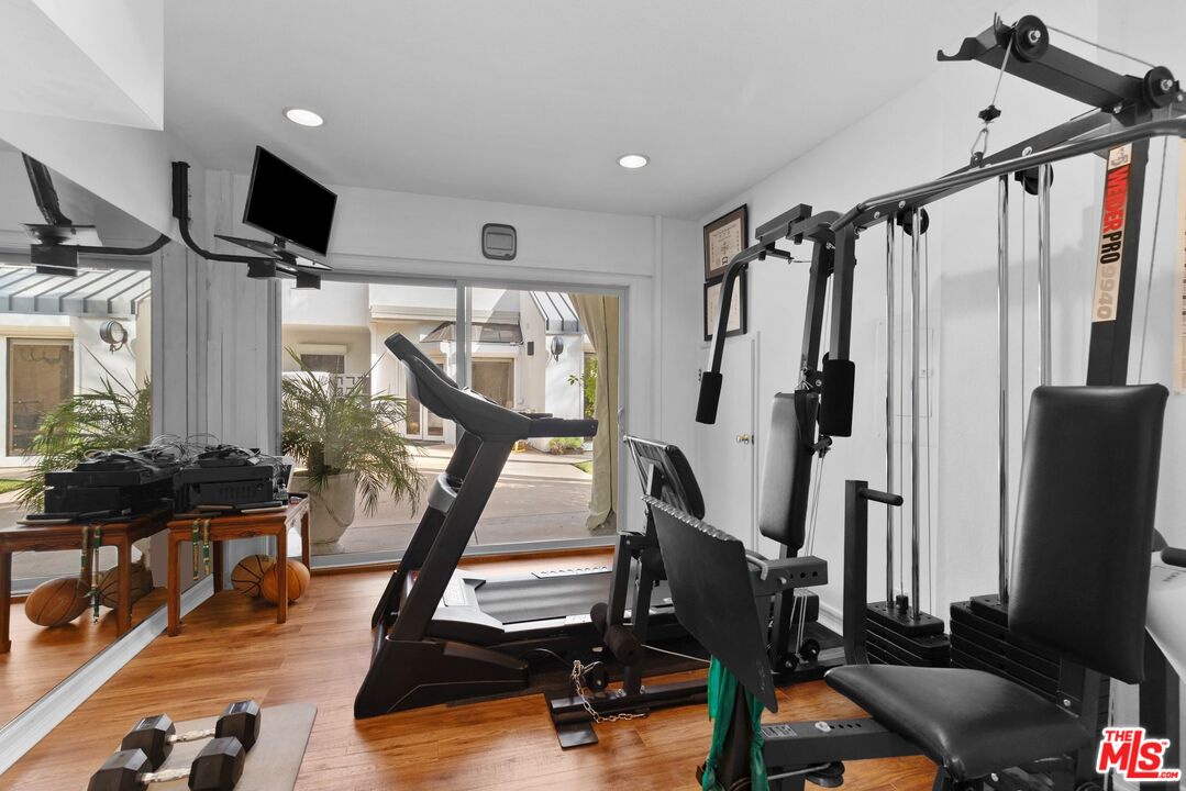 605 North Hillcrest Road Beverly Hills, CA 90210 - Photo 32 of 36 a view of a livingroom with furniture and a flat screen tv
