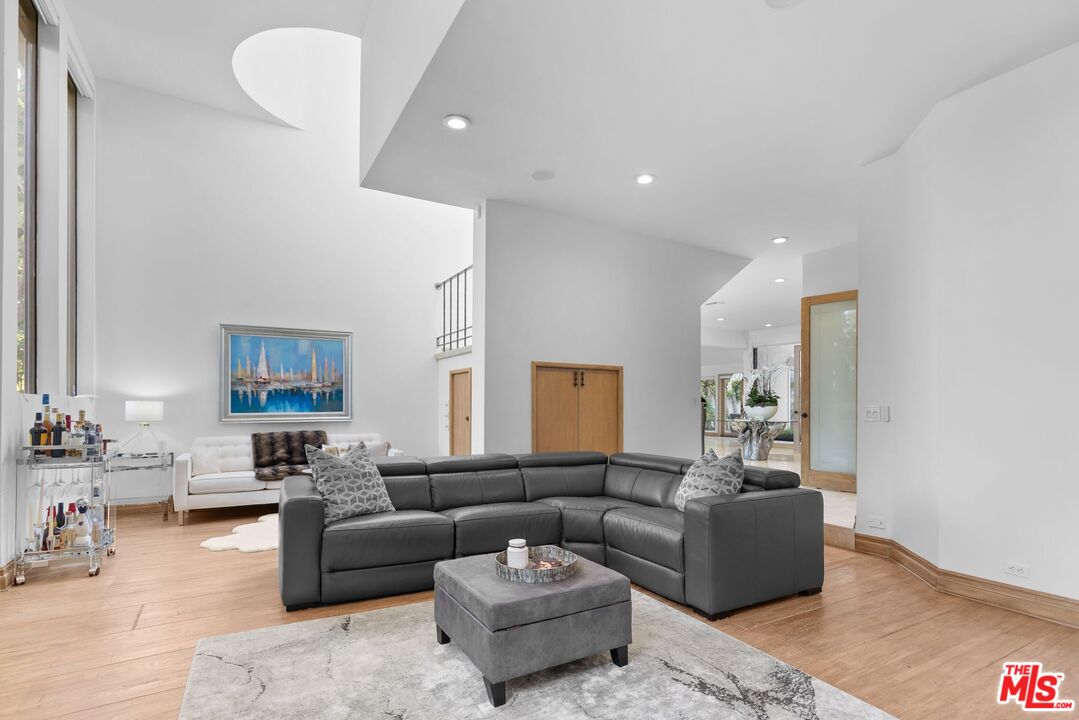 605 North Hillcrest Road Beverly Hills, CA 90210 - Photo 10 of 36 a living room with furniture and a wooden floor
