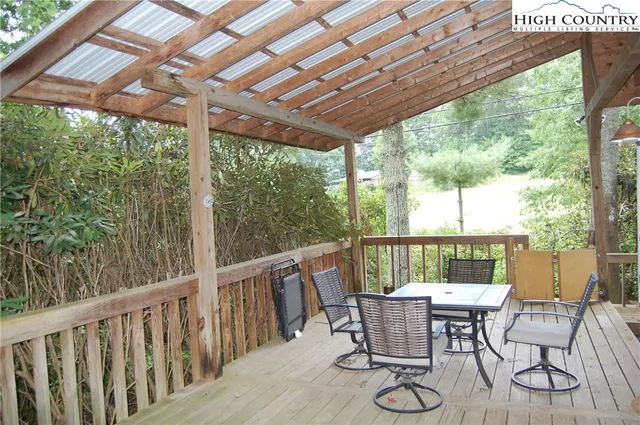 a view of a patio with table and chairs and wooden floor