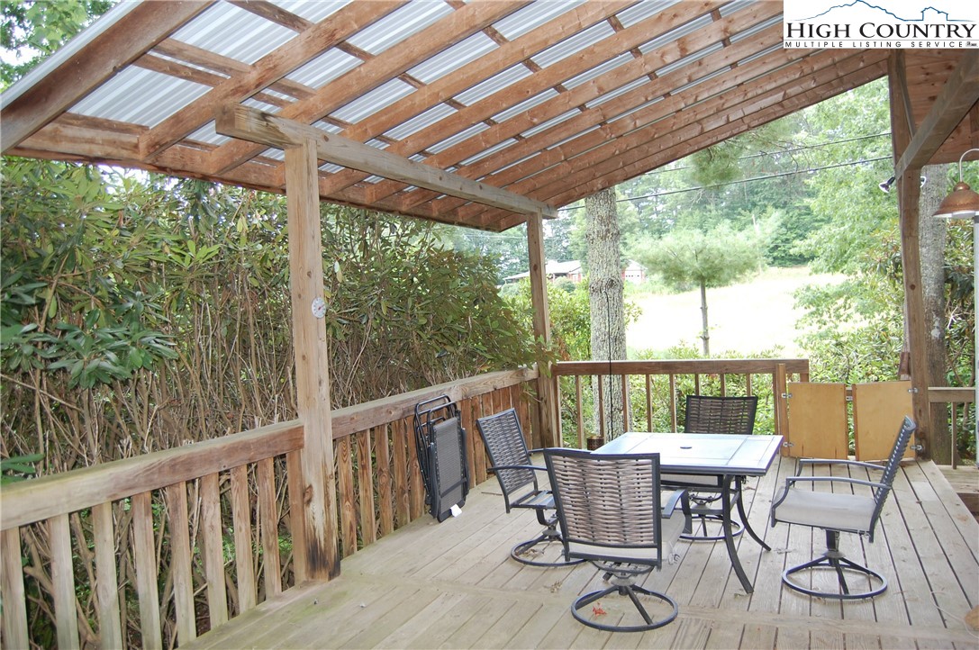 158 Trillium Road Newland, NC 28657 - Photo 4 of 12 a view of a patio with table and chairs and wooden floor