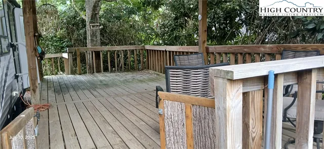 a view of balcony with wooden floor and fence