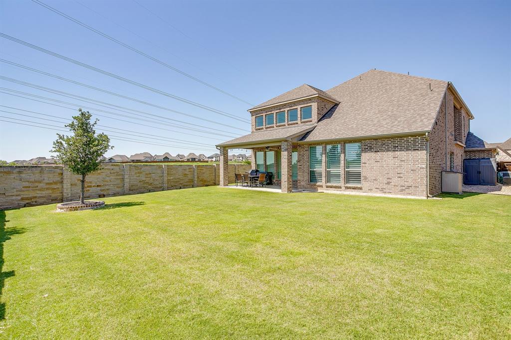 5709 Pope Creek Road Fort Worth, TX 76126 - Photo 36 of 39 Spacious backyard featuring a manicured lawn and a beautiful brick privacy wall!
