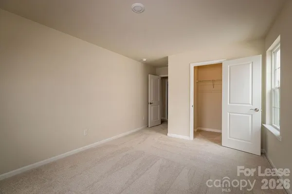 a view of an empty room and a window