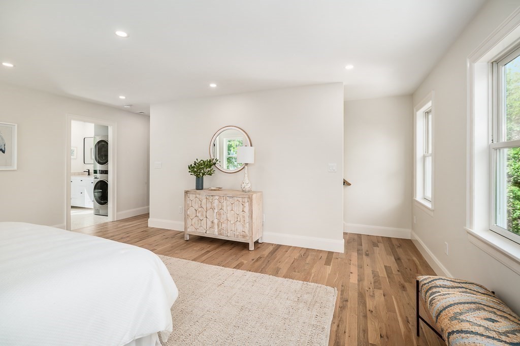 5 Samoset Road, Unit A Gloucester, MA 01930 - Photo 17 of 41 a spacious bedroom with a bed a dresser and a large window