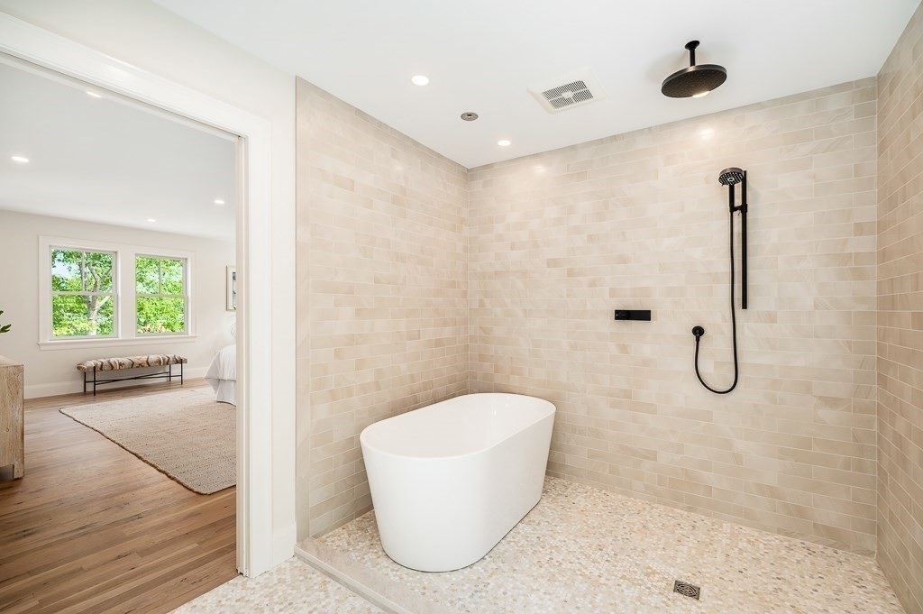 5 Samoset Road, Unit A Gloucester, MA 01930 - Photo 19 of 41 a bathroom with a granite countertop bathtub shower and a sink