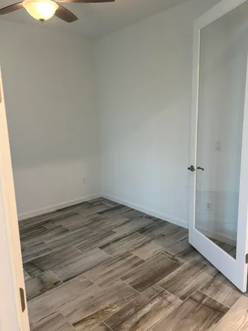 a view of a room with wooden floor