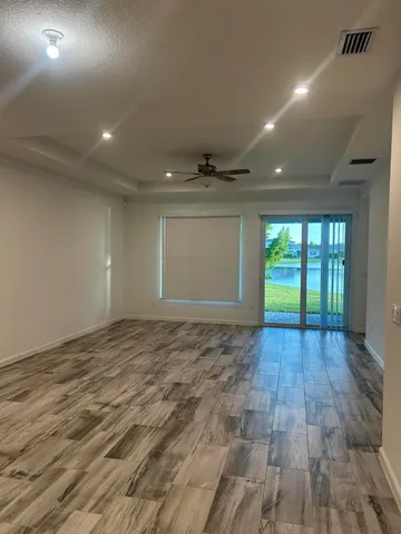 a large kitchen with kitchen island a sink dishwasher a stove and a refrigerator with wooden floor