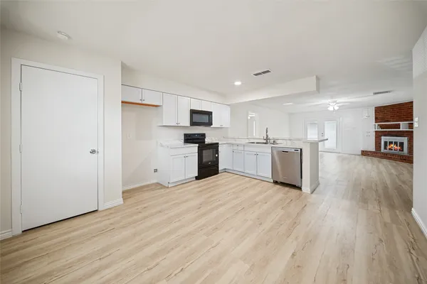 a view of kitchen with wooden floor and electronic appliances