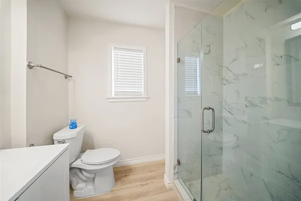 a white toilet sitting next to a bathroom sink