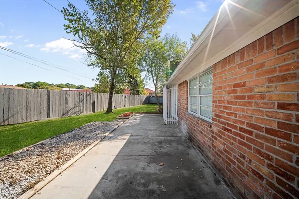 a view of a house with a yard and a garden