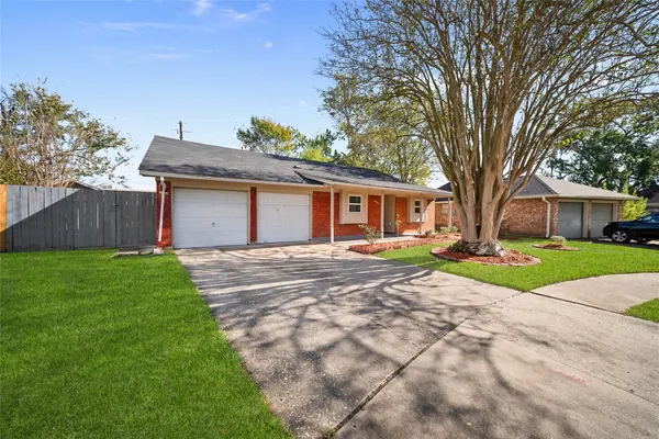 a view of a house with yard and tree s