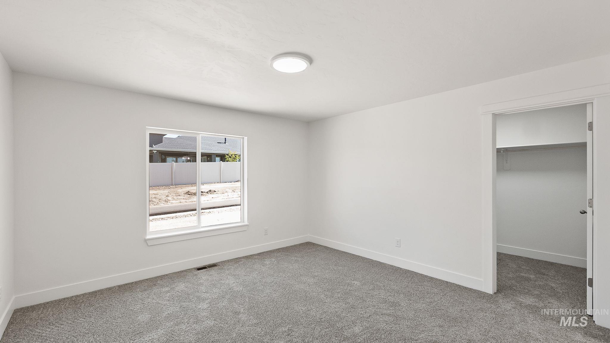 1440 Castle Way Emmett, ID 83617 - Photo 14 of 30 Unfurnished bedroom featuring a spacious closet and light carpet