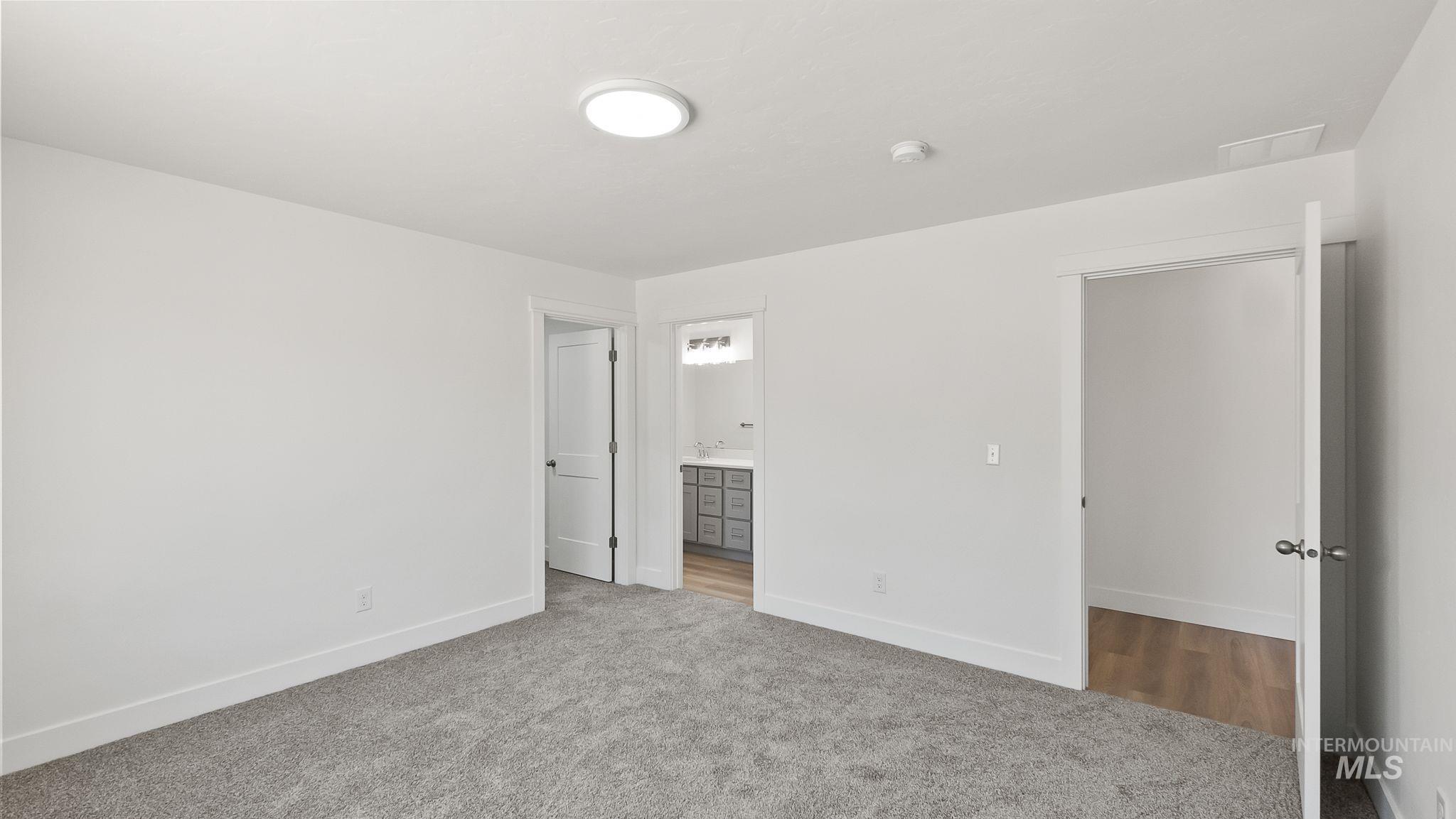 1440 Castle Way Emmett, ID 83617 - Photo 15 of 30 Unfurnished bedroom with ensuite bath and carpet floors