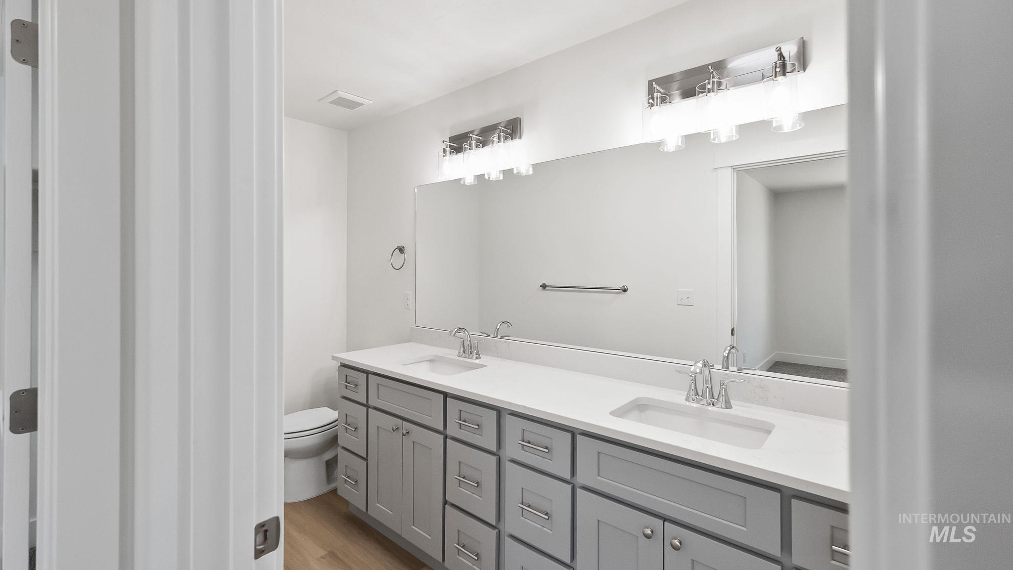 1440 Castle Way Emmett, ID 83617 - Photo 16 of 30 Bathroom with double vanity and light wood-style flooring