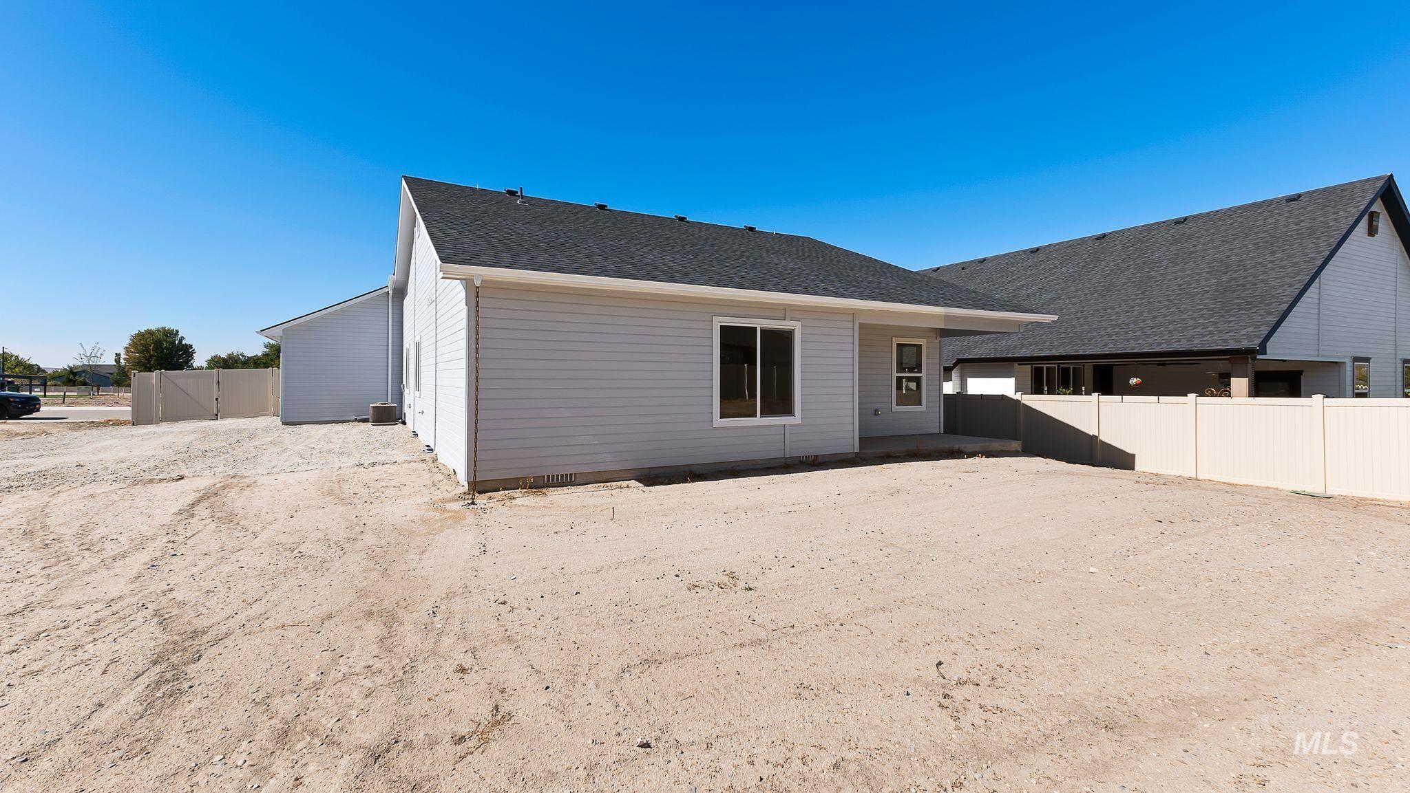 1440 Castle Way Emmett, ID 83617 - Photo 22 of 30 Rear view of house with a patio and roof with shingles