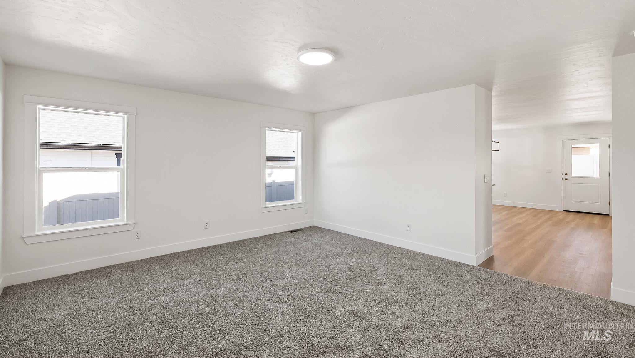 1440 Castle Way Emmett, ID 83617 - Photo 5 of 30 Carpeted spare room with baseboards and a textured ceiling