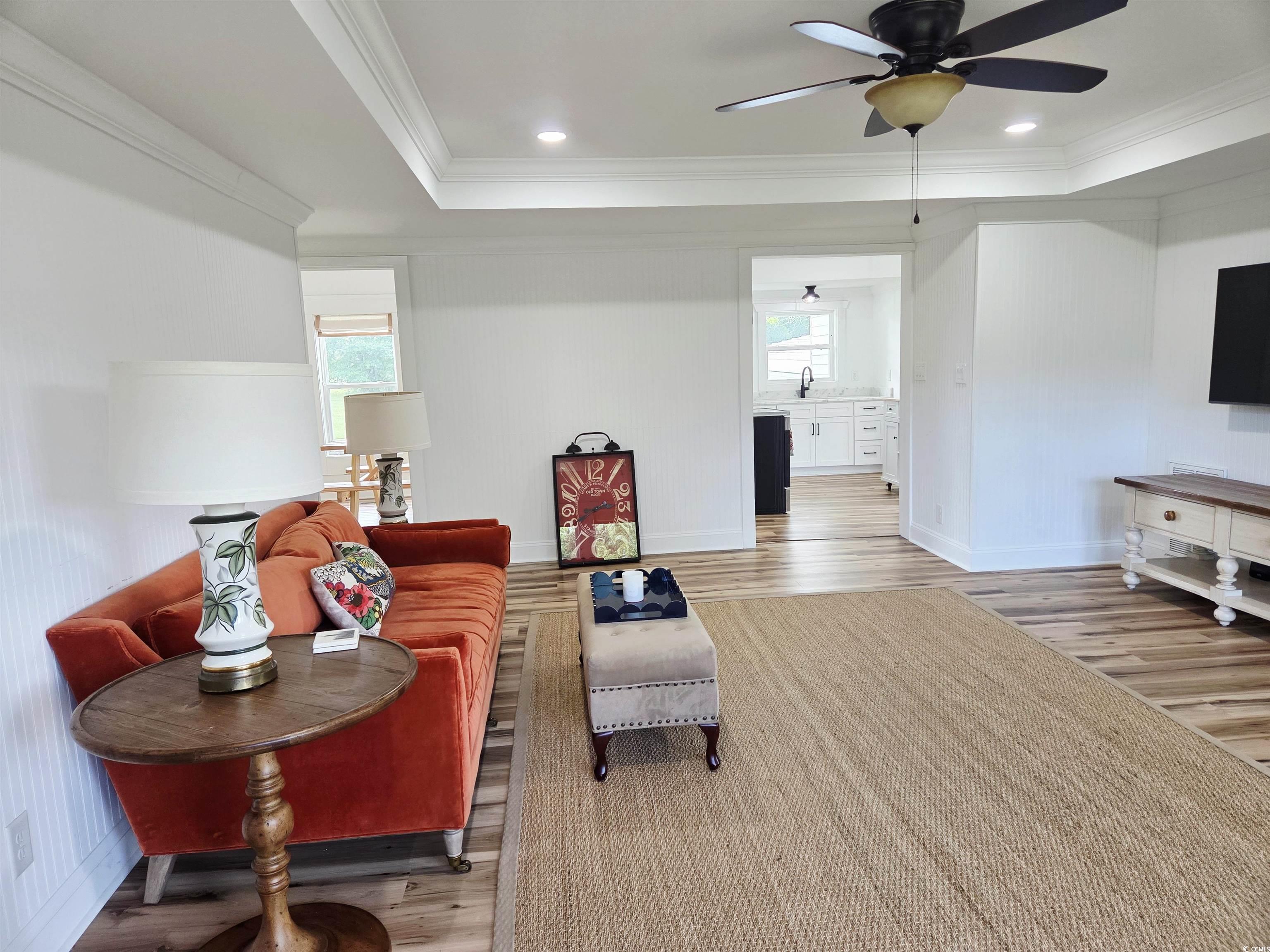 675 Liberty Church Road Loris, SC 29569 - Photo 11 of 35 Living area featuring a ceiling fan, a healthy amount of sunlight, and wood finished floors