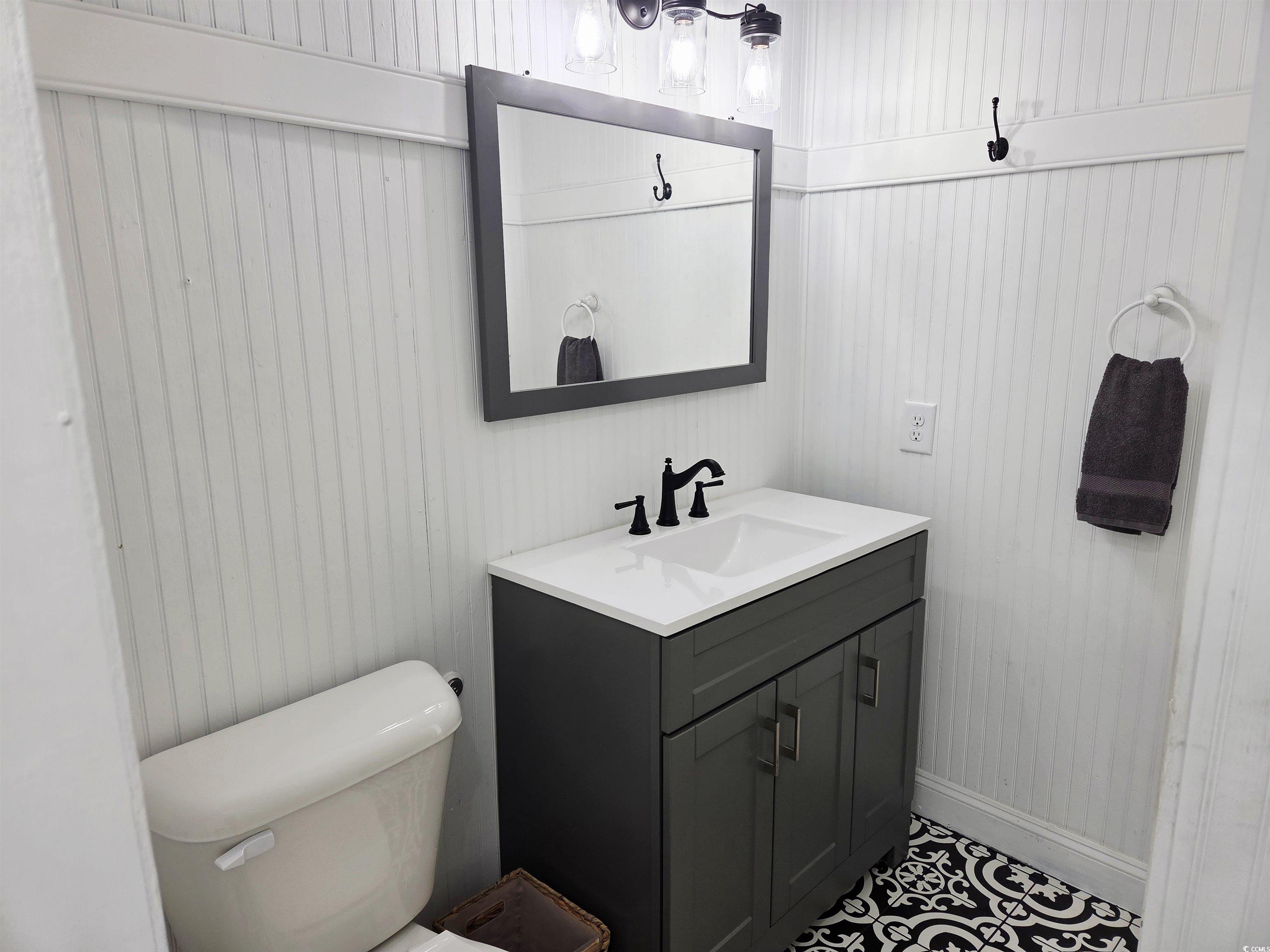 675 Liberty Church Road Loris, SC 29569 - Photo 16 of 35 Bathroom featuring vanity, toilet, baseboards, and tile patterned floors