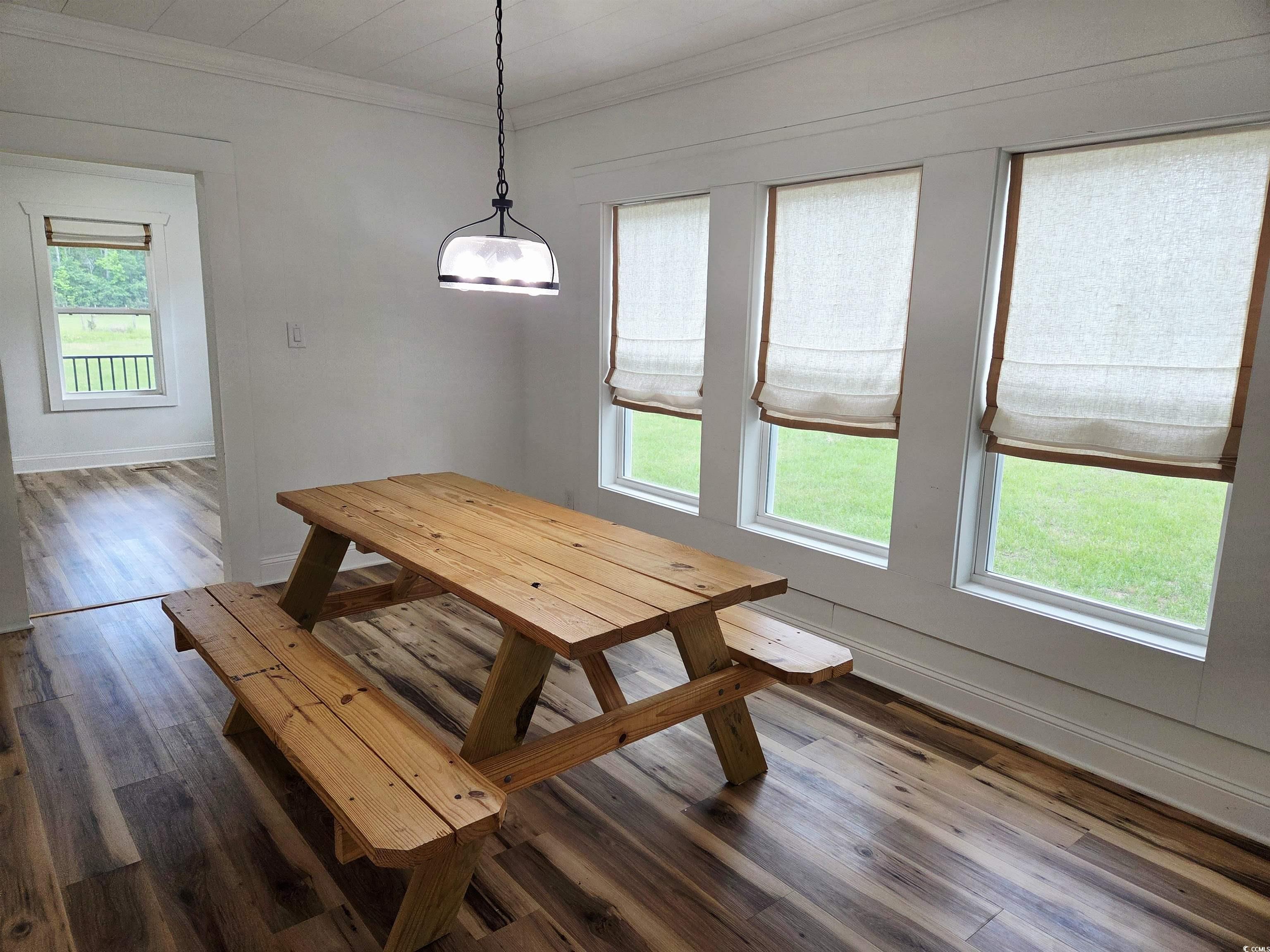 675 Liberty Church Road Loris, SC 29569 - Photo 18 of 35 Dining room featuring crown molding, baseboards, a healthy amount of sunlight, and dark wood-style floors