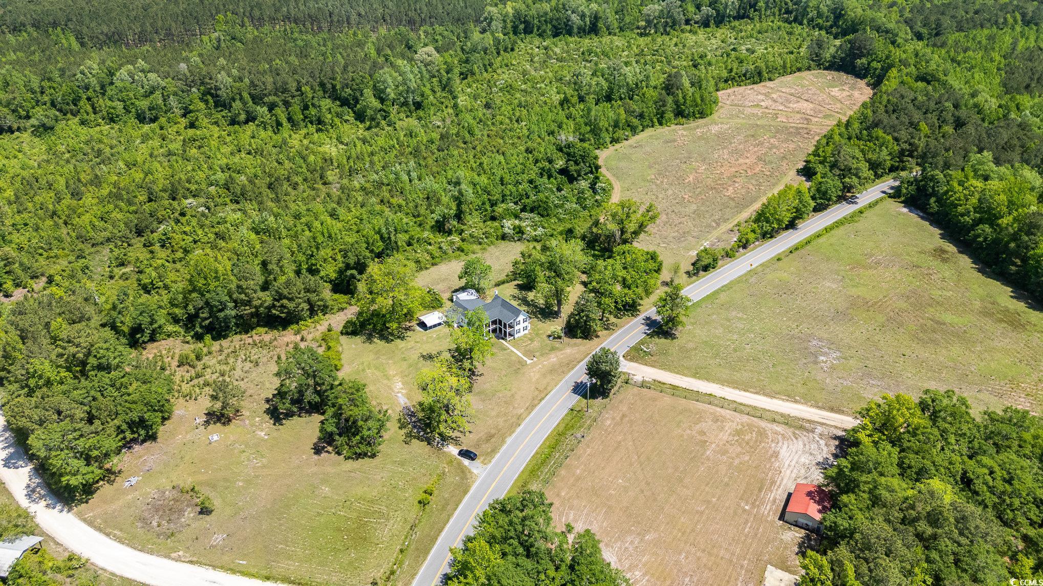 675 Liberty Church Road Loris, SC 29569 - Photo 2 of 35 Aerial view featuring a rural view and a forest view