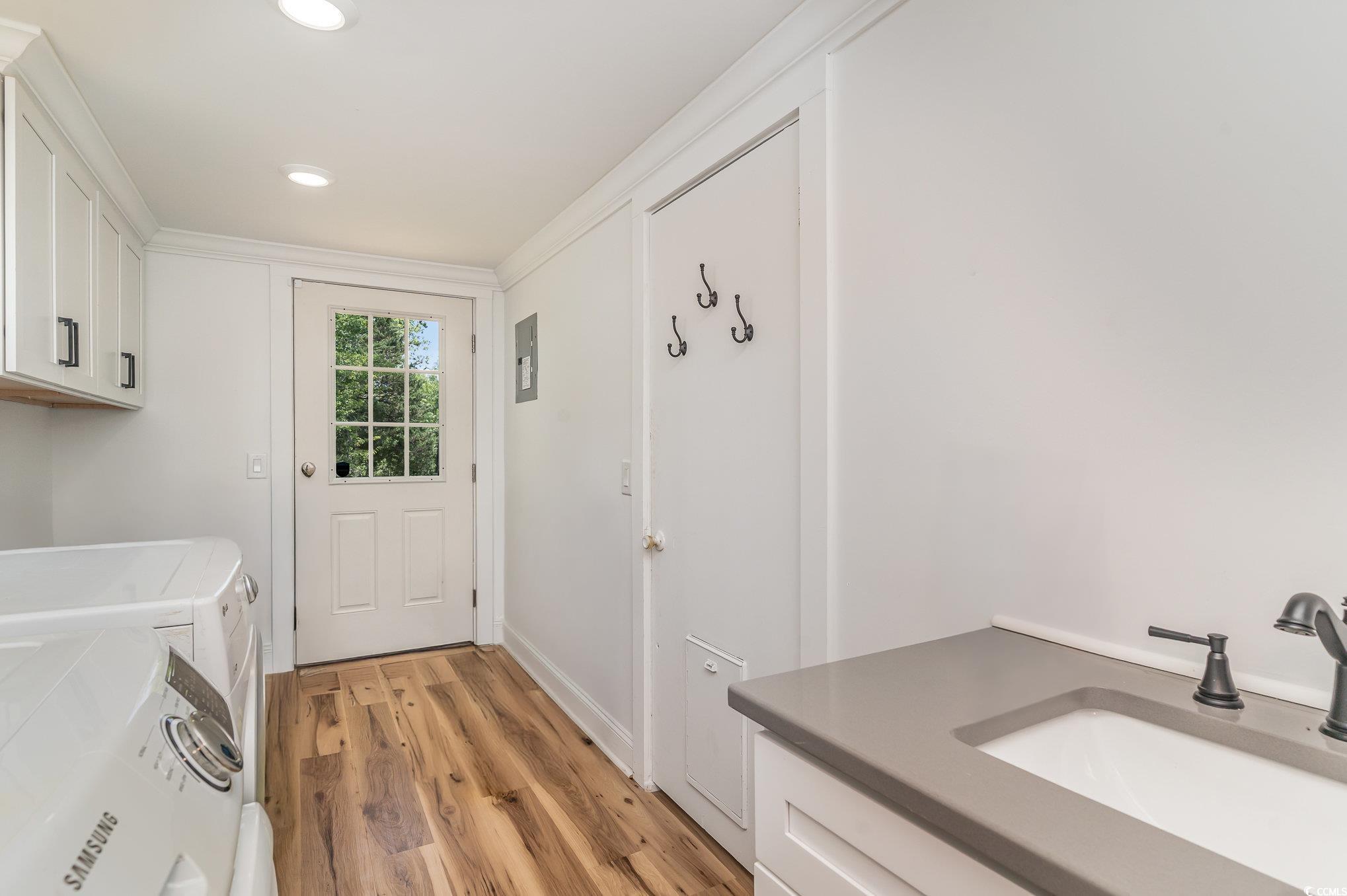675 Liberty Church Road Loris, SC 29569 - Photo 24 of 35 Washroom with independent washer and dryer, recessed lighting, light wood finished floors, a sink, and cabinet space