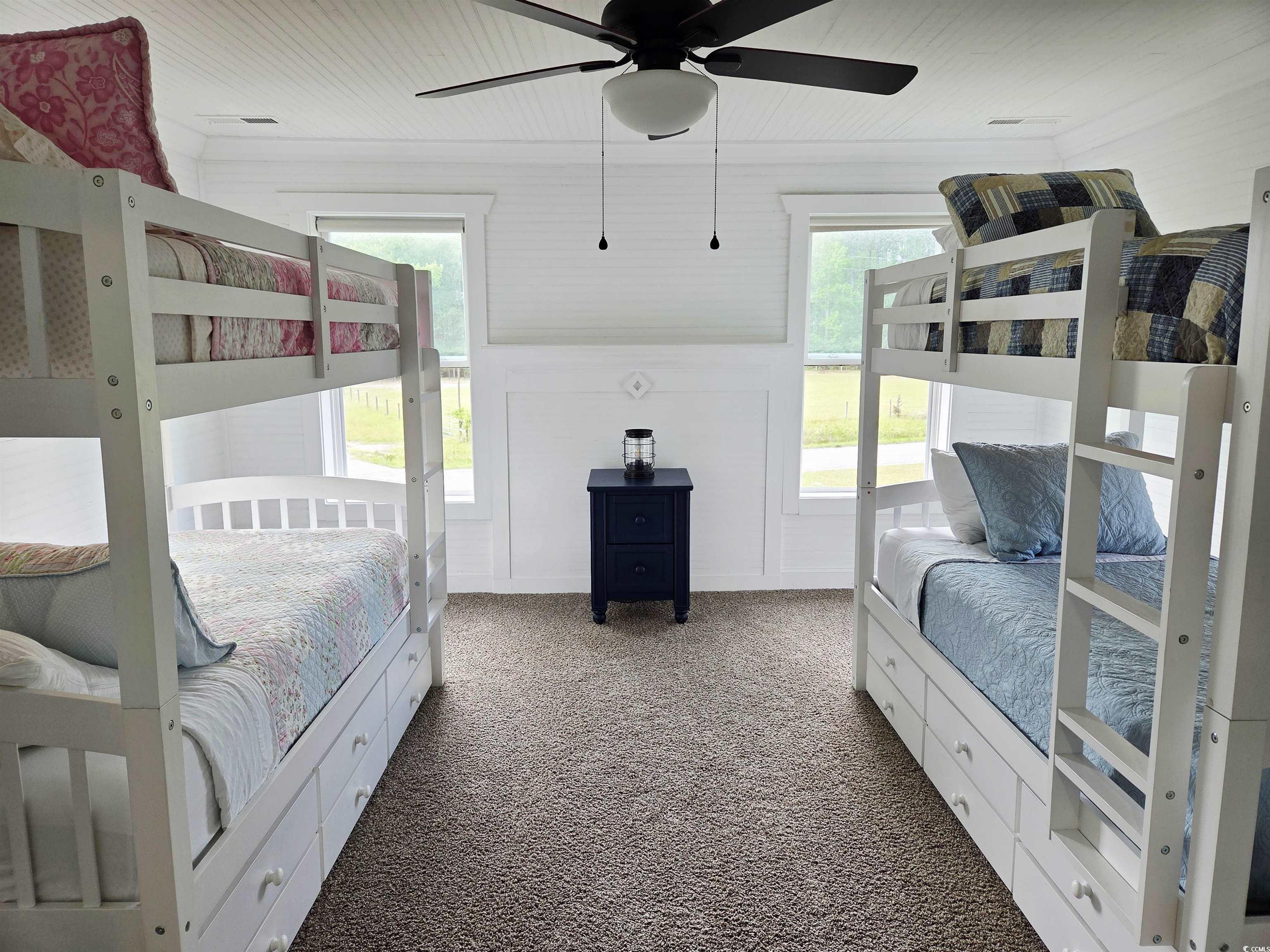 675 Liberty Church Road Loris, SC 29569 - Photo 28 of 35 Carpeted bedroom with multiple windows, ceiling fan, and wood ceiling
