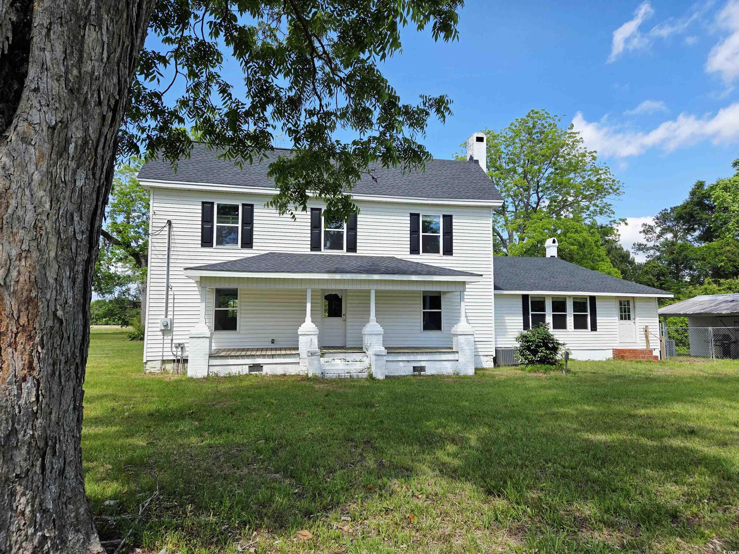675 Liberty Church Road Loris, SC 29569 - Photo 4 of 35 View of front of house with a chimney, a porch, and a front lawn