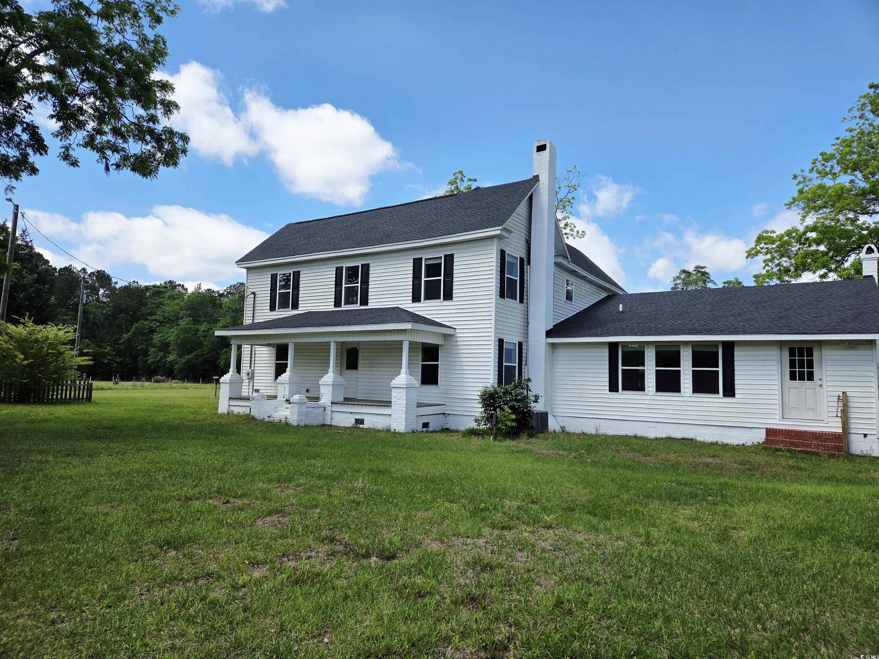 675 Liberty Church Road Loris, SC 29569 - Photo 5 of 35 View of front of house featuring a porch, roof with shingles, a front lawn, and a chimney