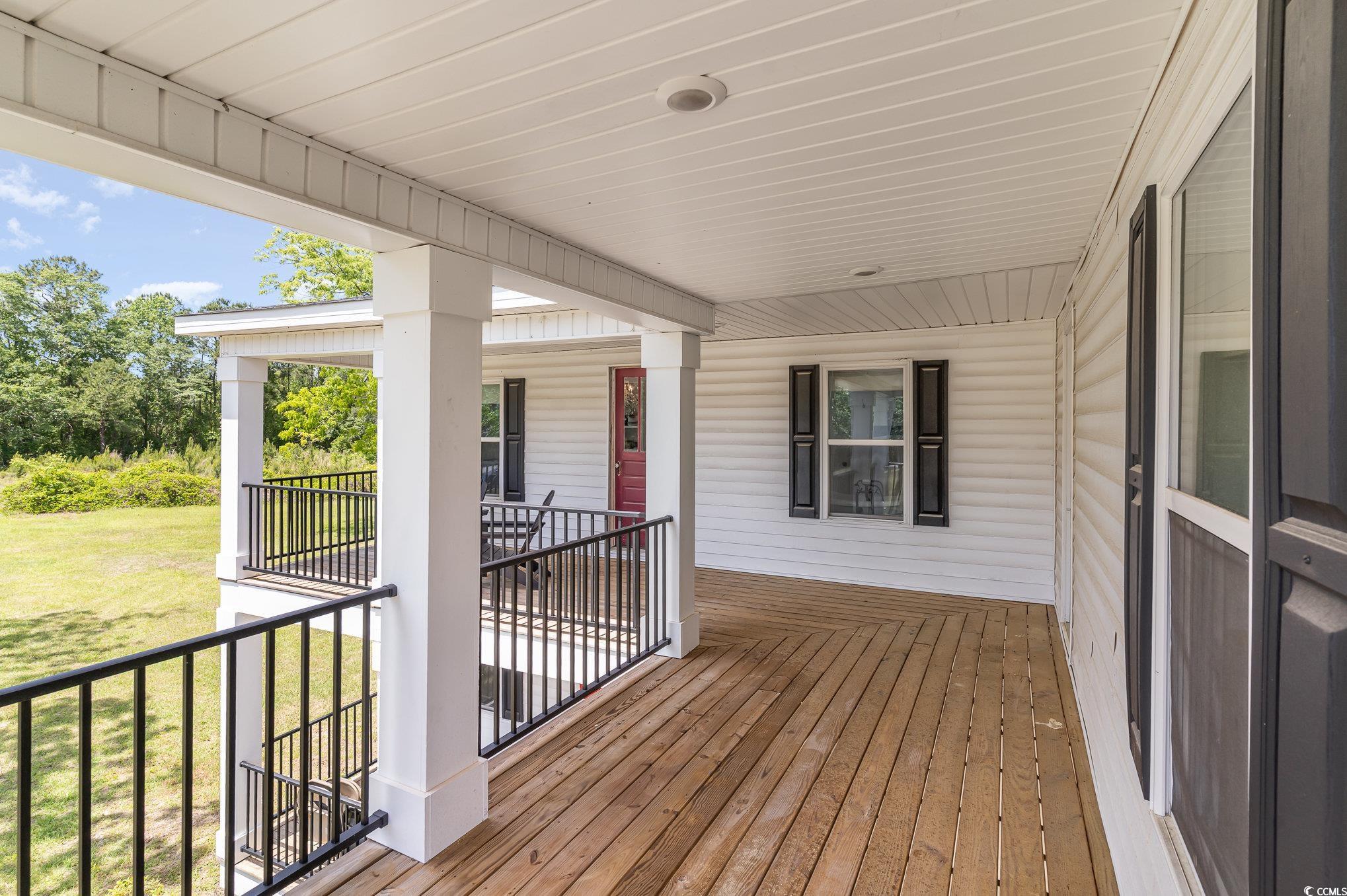 675 Liberty Church Road Loris, SC 29569 - Photo 9 of 35 Wooden terrace with covered porch and a yard