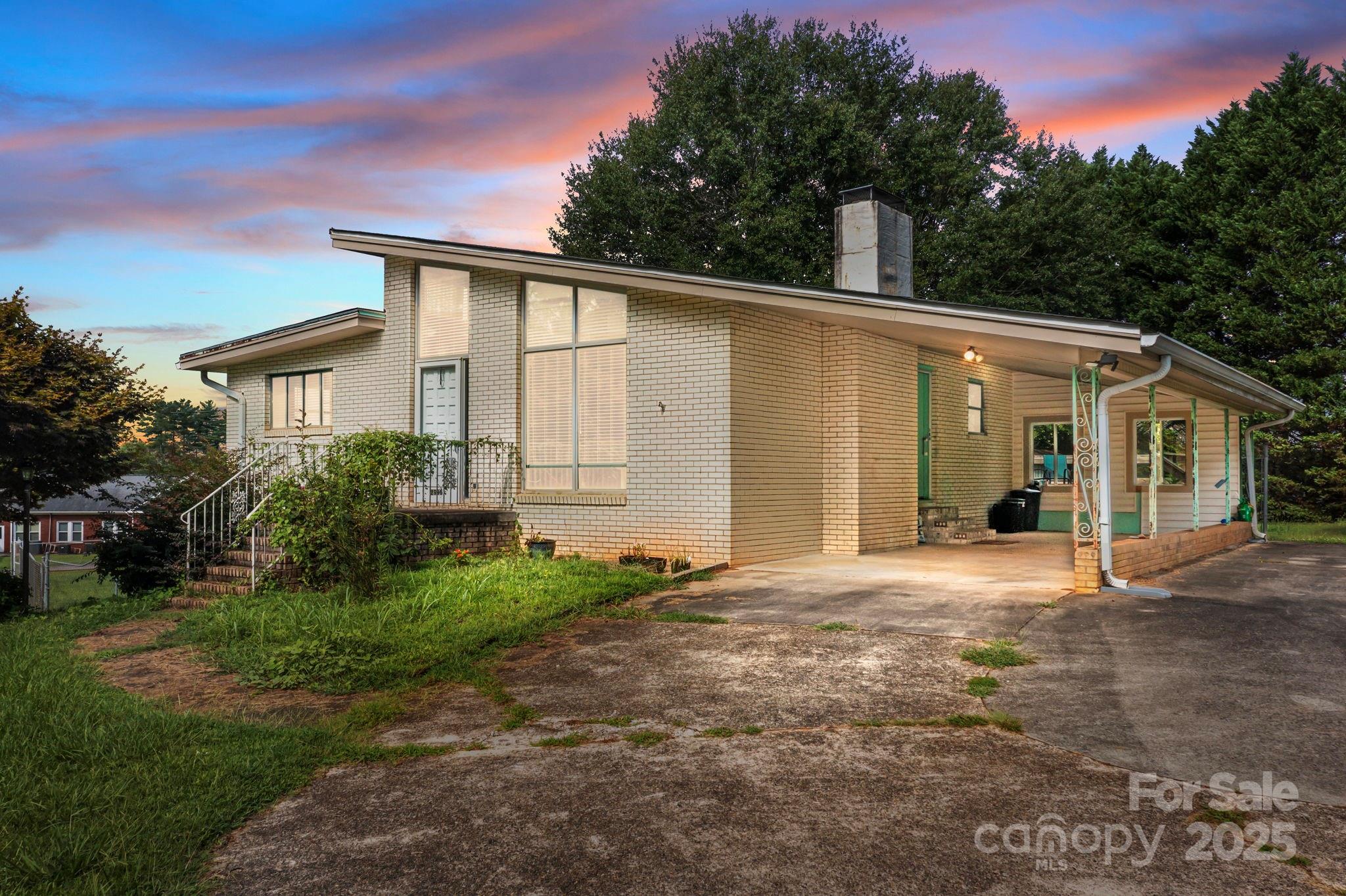 a front view of a house with a garden and yard