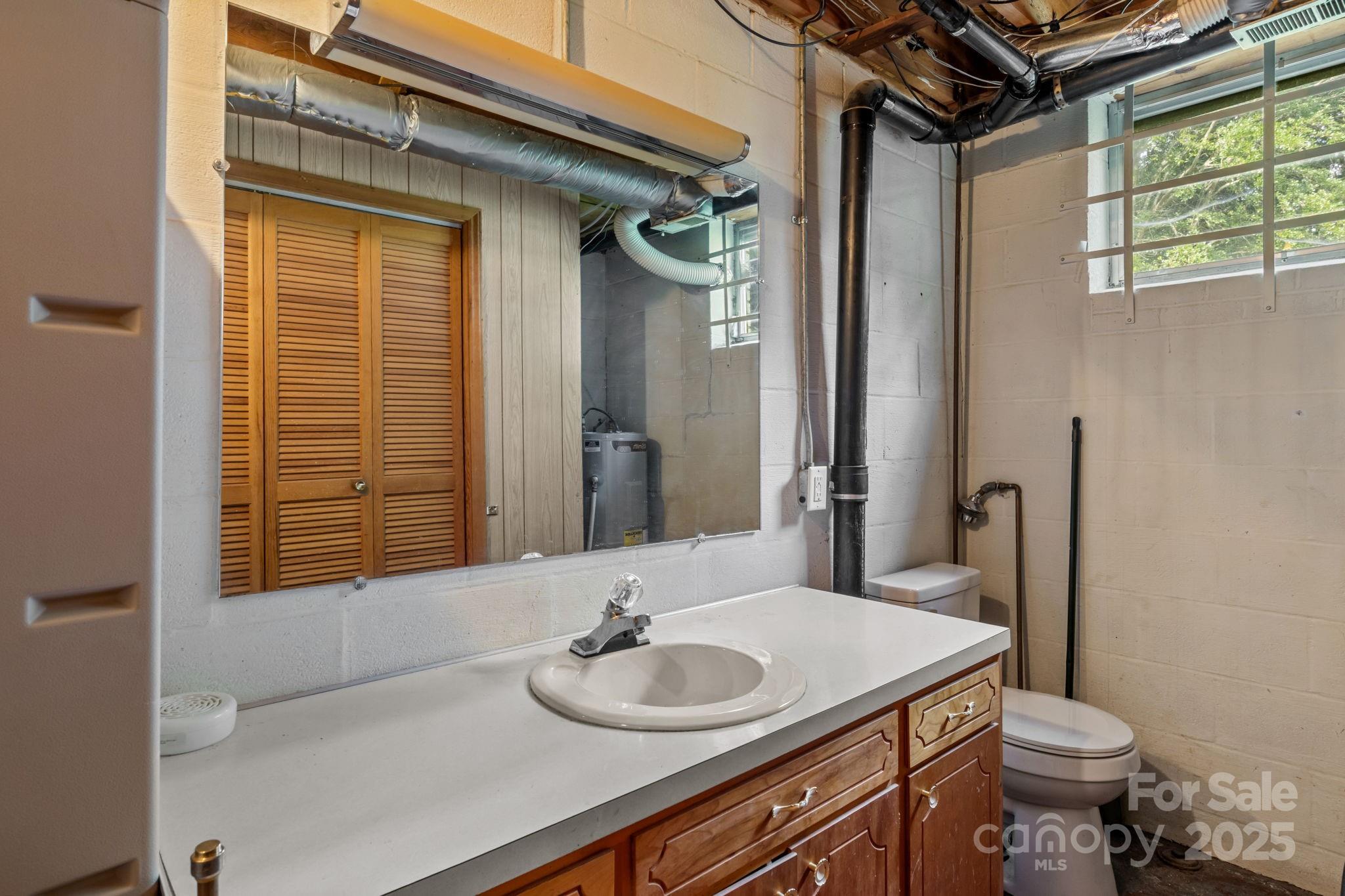 2988 Wesleyan Church Road Lincolnton, NC 28092 - Photo 19 of 24 a bathroom with a granite countertop sink toilet and mirror