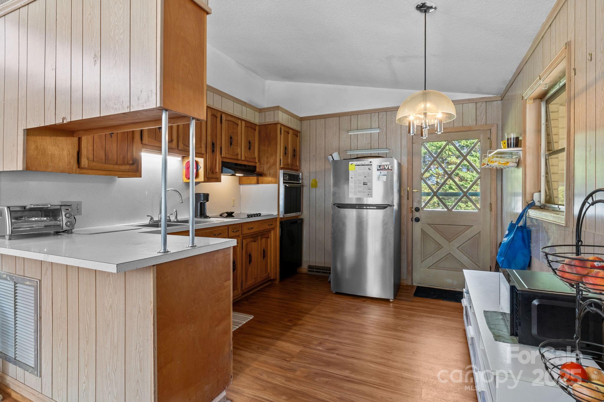 2988 Wesleyan Church Road Lincolnton, NC 28092 - Photo 5 of 24 a kitchen with stainless steel appliances granite countertop a refrigerator a stove a sink dishwasher and a refrigerator with wooden floor