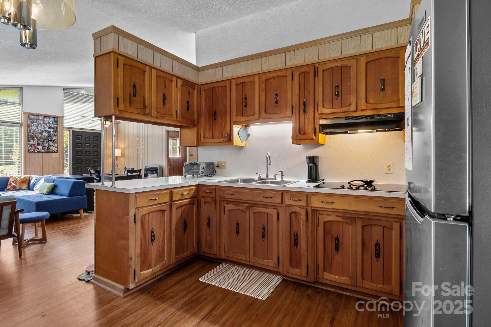 2988 Wesleyan Church Road Lincolnton, NC 28092 - Photo 8 of 24 a kitchen with stainless steel appliances granite countertop a refrigerator a sink dishwasher a stove and white cabinets with wooden floor