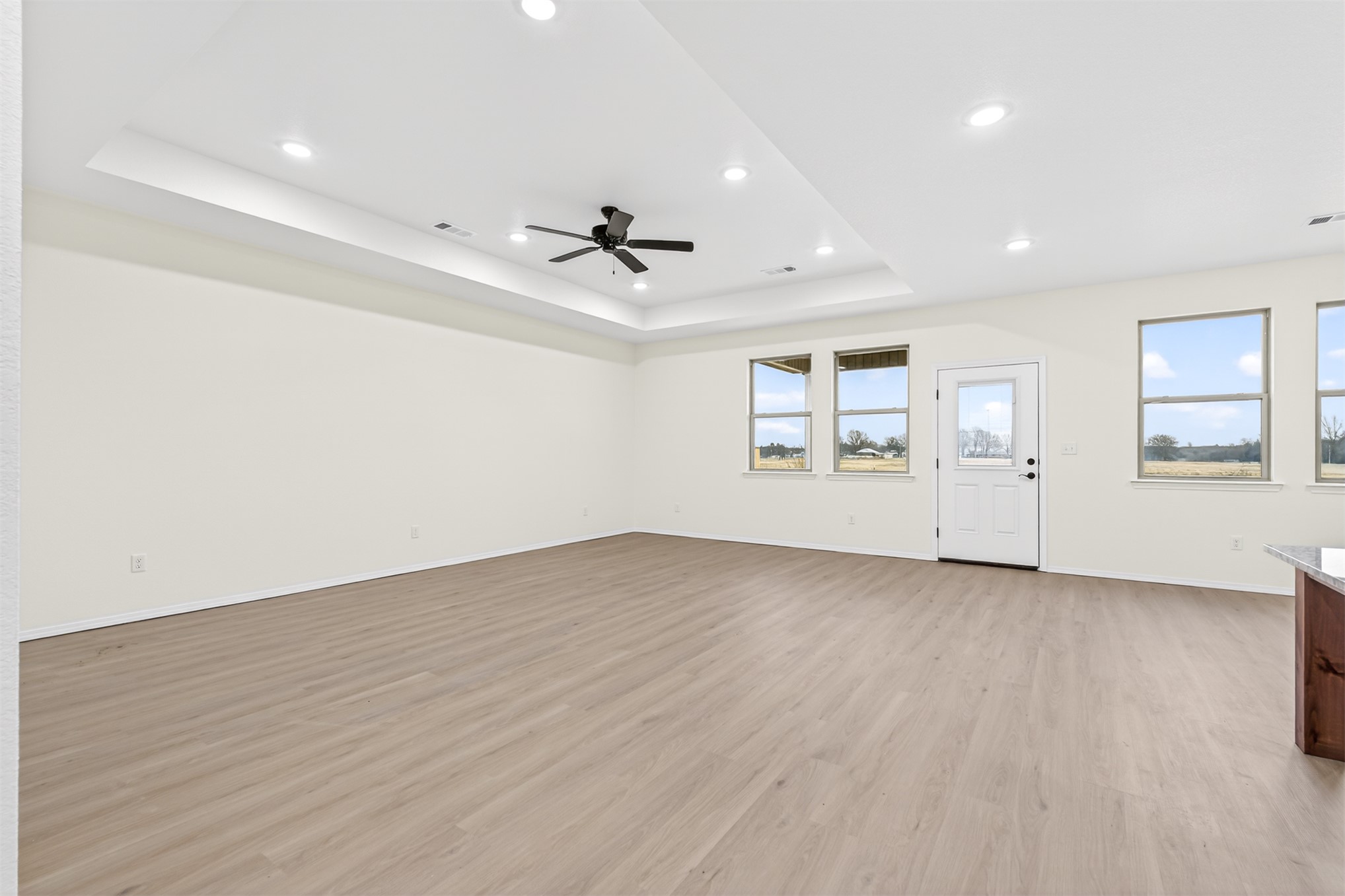 124 Countryside Way Pocola, OK 74902 - Photo 10 of 39 Recessed lighting, wood-finish flooring, ceiling fan, multiple windows, and a glass-paneled exterior door