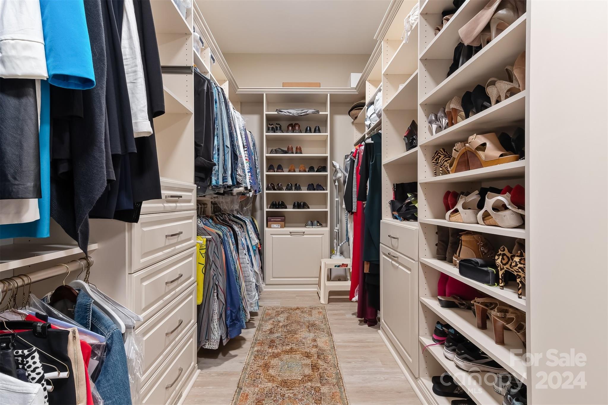 15608 Lake Ridge Road Charlotte, NC 28278 - Photo 19 of 37 a view of walk in closet with clothes and shoes