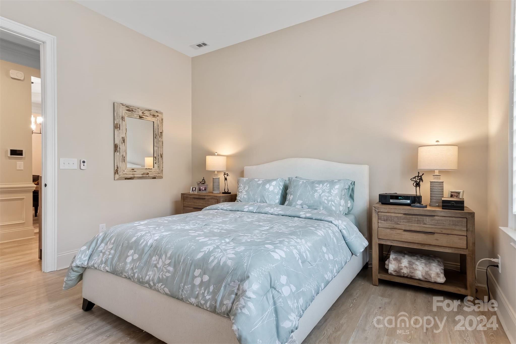 15608 Lake Ridge Road Charlotte, NC 28278 - Photo 20 of 37 a bedroom with a bed and a lamp