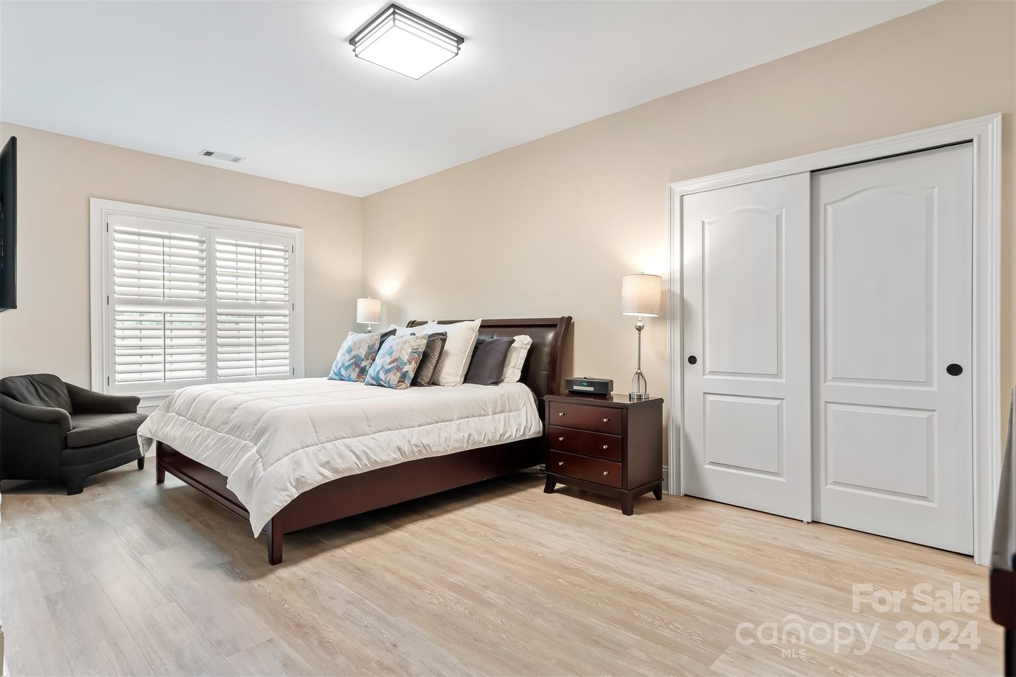 15608 Lake Ridge Road Charlotte, NC 28278 - Photo 26 of 37 a bedroom with a bed and a couch