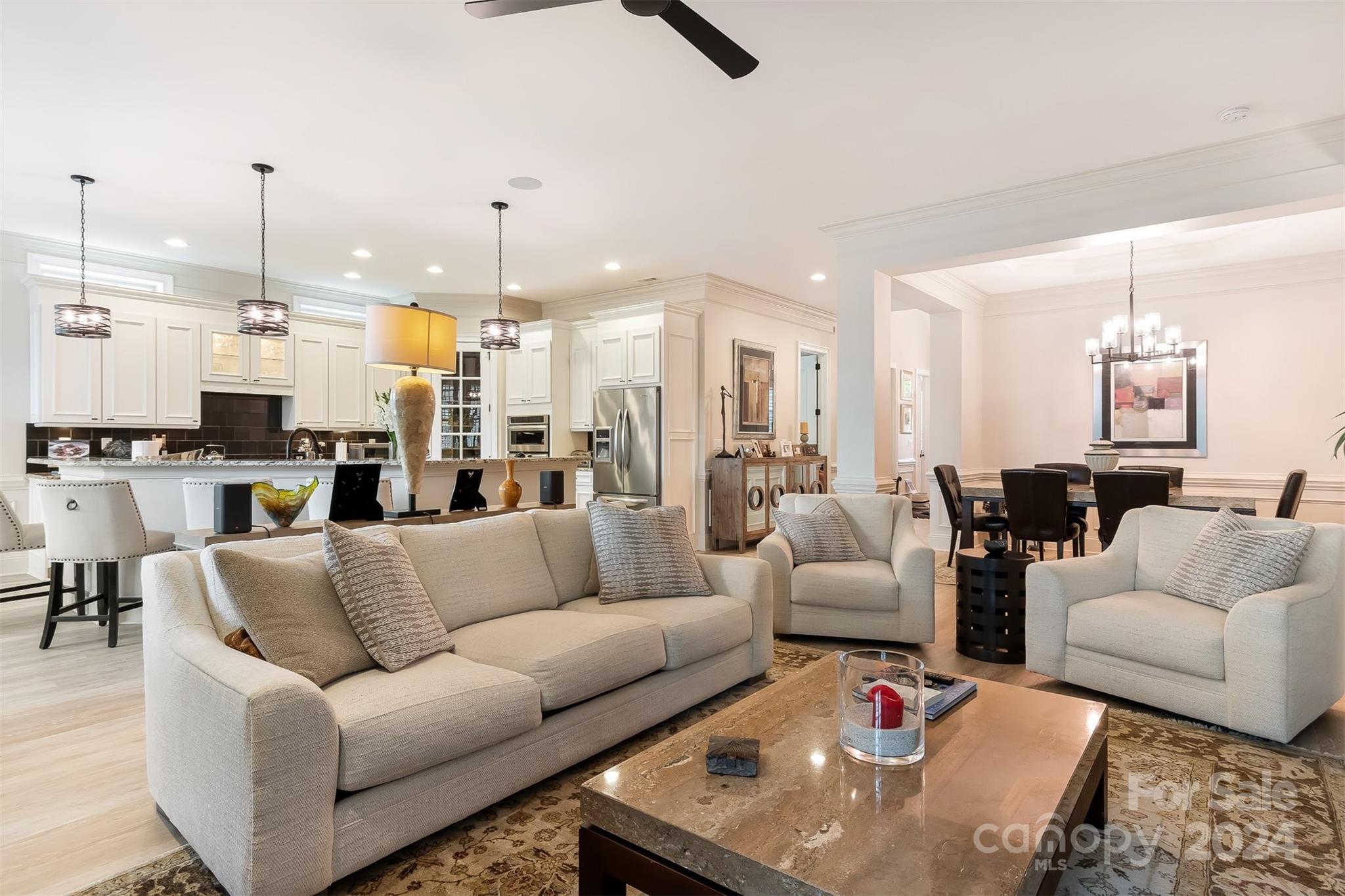 15608 Lake Ridge Road Charlotte, NC 28278 - Photo 7 of 37 a living room with furniture kitchen view and a chandelier