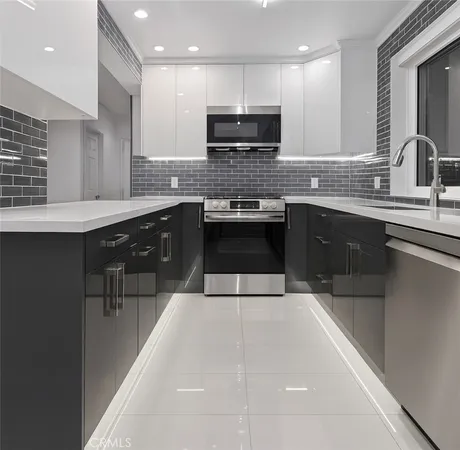 a large kitchen with a sink and cabinets