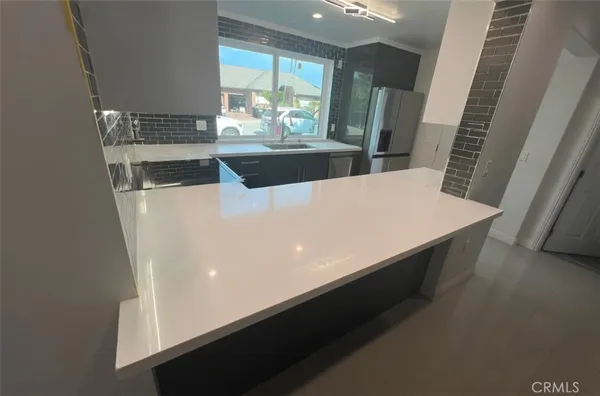 a view of kitchen with furniture and wooden floor